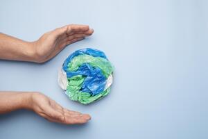 close-up-hand-with-plastic-earth.jpg