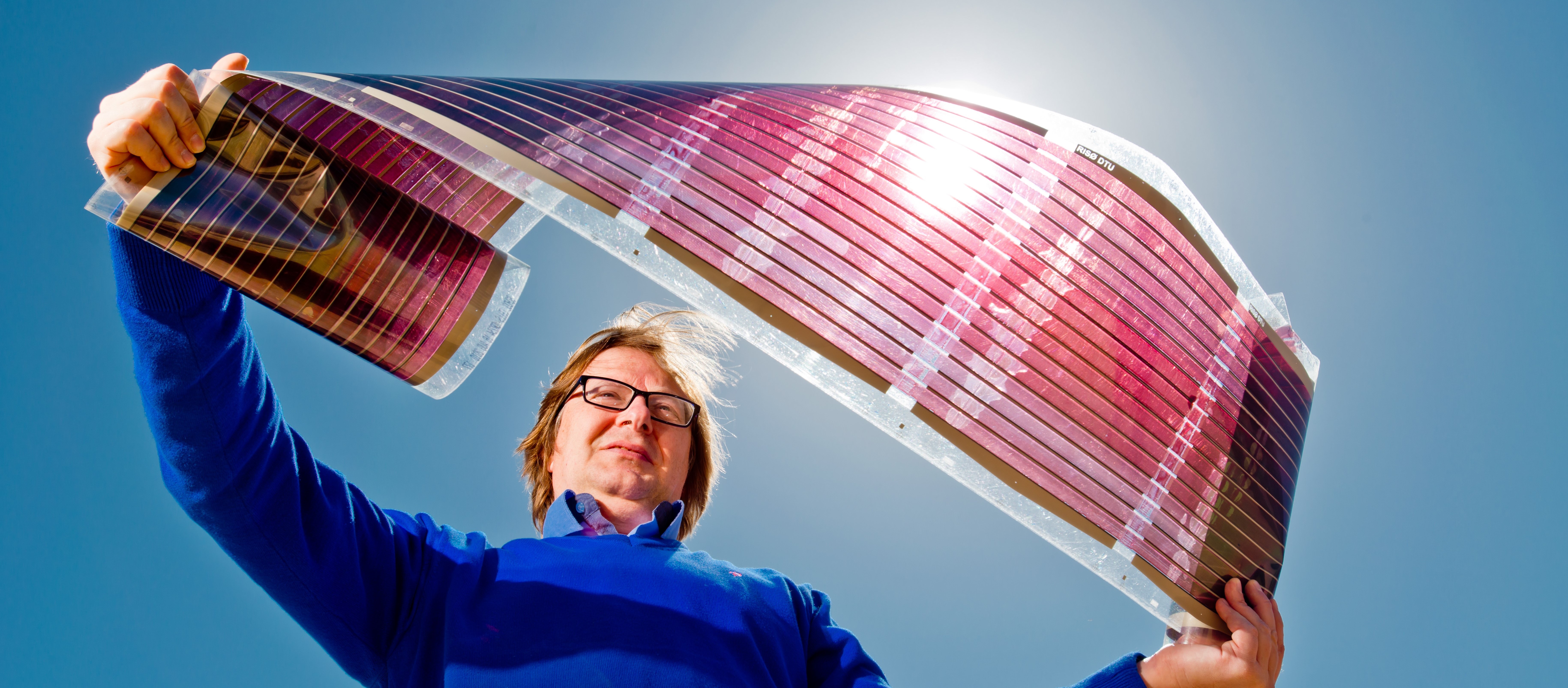 Prof. Eugene Katz of the National Solar Energy Center demonstrates flexible photovoltaic surfaces