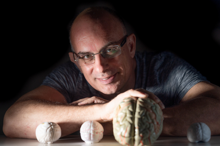 Prof. Oren Shriki with models of brains