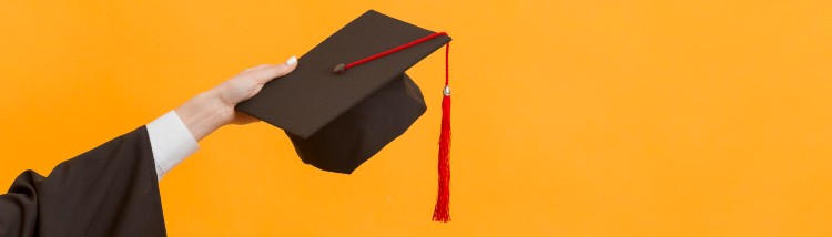 close-up-graduate-student-holding-cap.jpg