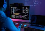 it-specialist-checking-code-computer-dark-office-night.jpg